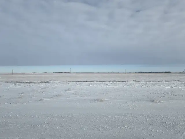Snowy prairie fields and railway line